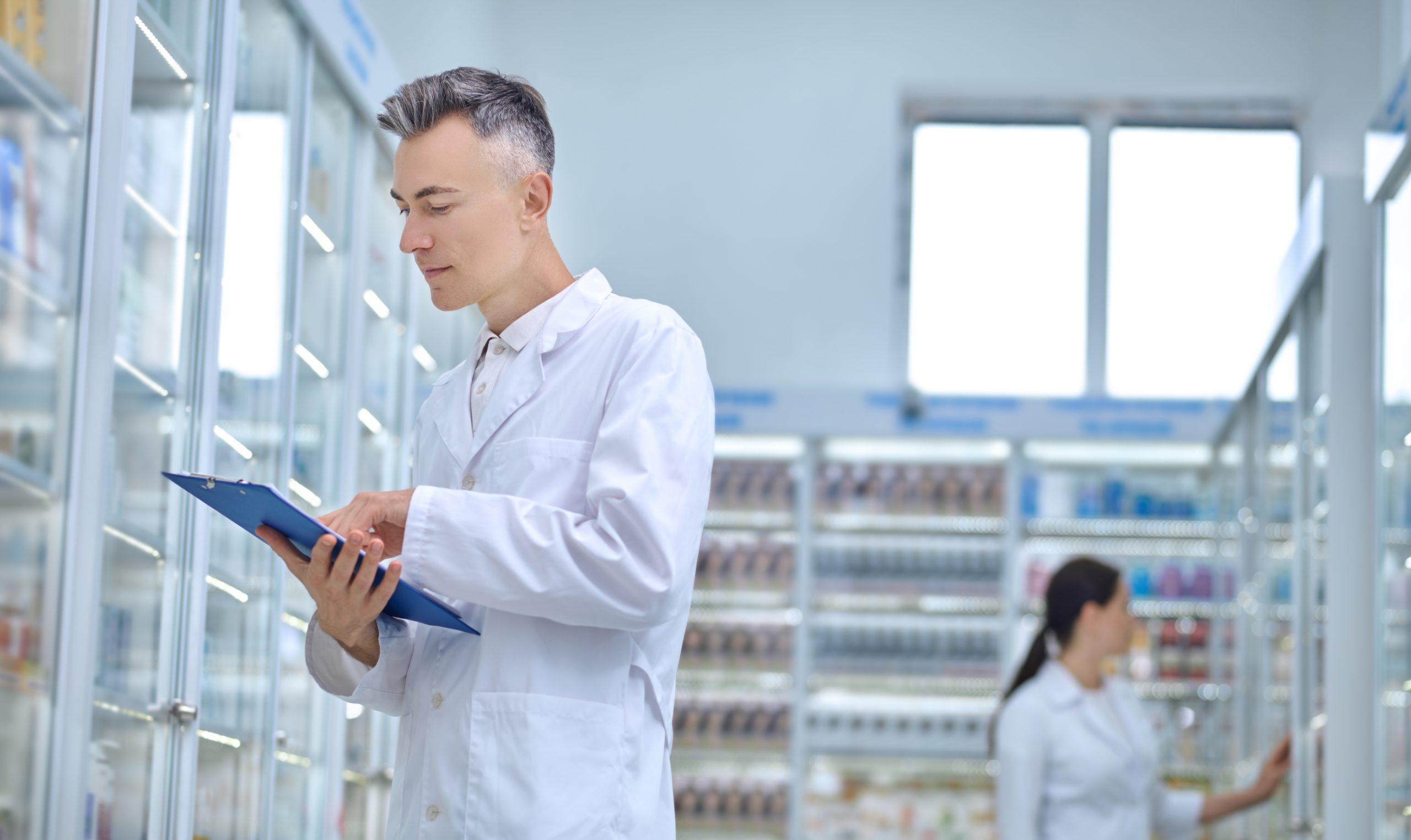 Revision. Two pharmacists making medicines revision in a drugstore